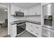 Bright kitchen with stainless steel appliances, modern countertops, and ample cabinet space at 852 Village Way, Palm Harbor, FL 34683