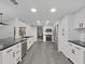 Spacious kitchen featuring stainless steel appliances, modern countertops, and ample cabinet space at 852 Village Way, Palm Harbor, FL 34683