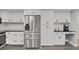 Modern kitchen featuring stainless steel refrigerator, sleek countertops, and ample cabinet space at 852 Village Way, Palm Harbor, FL 34683