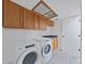 Functional laundry room featuring modern washer and dryer at 852 Village Way, Palm Harbor, FL 34683