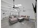 Open-concept living room and kitchen, with modern gray flooring and plenty of seating at 852 Village Way, Palm Harbor, FL 34683