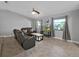 Comfortable living room with tile flooring, two windows, and stylish furniture at 852 Village Way, Palm Harbor, FL 34683