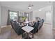 Comfortable living room with tile flooring, two windows, and stylish leather furniture at 852 Village Way, Palm Harbor, FL 34683