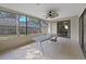 Relaxing screened patio provides a serene view of the backyard and neighborhood at 852 Village Way, Palm Harbor, FL 34683