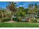 Welcome to Westlake Village, featuring a beautifully landscaped entrance with lush greenery at 852 Village Way, Palm Harbor, FL 34683
