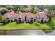 Aerial view of community showcases meticulously maintained lawns and a serene pond at 9481 Highland Oak Dr # 1101, Tampa, FL 33647