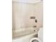 Clean bathroom features a bathtub with tile surround at 9481 Highland Oak Dr # 1101, Tampa, FL 33647