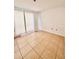 Sunlit bedroom features tile flooring and minimalist design at 9481 Highland Oak Dr # 1101, Tampa, FL 33647