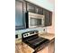 Modern kitchen with stainless steel appliances, granite countertops, and ample cabinet space at 9481 Highland Oak Dr # 1101, Tampa, FL 33647