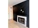Living room featuring a black accent wall and a cozy fireplace with marble tile surround at 9481 Highland Oak Dr # 1101, Tampa, FL 33647