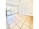 Open living room with natural light and tile flooring with access to patio at 9481 Highland Oak Dr # 1101, Tampa, FL 33647