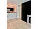 Open-concept living room with a modern fireplace, tile flooring, and neutral paint at 9481 Highland Oak Dr # 1101, Tampa, FL 33647