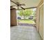 Screened patio with ceiling fan overlooks the lawn and parking area, providing a relaxing outdoor space at 9481 Highland Oak Dr # 1101, Tampa, FL 33647
