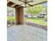 Screened patio with ceiling fan overlooks the lawn and parking area, perfect for relaxing outdoors at 9481 Highland Oak Dr # 1101, Tampa, FL 33647