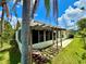 Back of house with enclosed porch, stone patio and shade trellis at 9614 Long Meadow Dr, Tampa, FL 33615