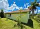 Backyard showing the property's lush yard, landscaping and proximity to the water at 9614 Long Meadow Dr, Tampa, FL 33615