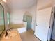 Bright bathroom featuring a soaking tub, glass-enclosed shower, and single sink vanity at 9614 Long Meadow Dr, Tampa, FL 33615