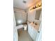 Bathroom featuring a shower with sliding glass door and white vanity sink at 9614 Long Meadow Dr, Tampa, FL 33615
