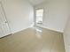 Bright bedroom with ceramic tile flooring, window, and neutral walls at 9614 Long Meadow Dr, Tampa, FL 33615