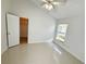 Bedroom featuring a ceiling fan, closet, and window with blinds at 9614 Long Meadow Dr, Tampa, FL 33615