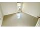 Bright bedroom with ceramic tile flooring, window, and neutral walls at 9614 Long Meadow Dr, Tampa, FL 33615