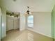 Sunlit dining area with tile flooring, a decorative chandelier, and a large window at 9614 Long Meadow Dr, Tampa, FL 33615