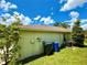 View of home exterior featuring well-maintained lawn, and external fixtures at 9614 Long Meadow Dr, Tampa, FL 33615