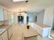 Bright kitchen featuring white cabinets, appliances, and tile floors at 9614 Long Meadow Dr, Tampa, FL 33615