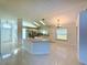 Spacious open-concept kitchen featuring tile flooring, a kitchen island, ample counter space, and natural light at 9614 Long Meadow Dr, Tampa, FL 33615