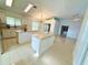 Spacious kitchen features a center island, tile flooring, modern appliances, and ample cabinet space at 9614 Long Meadow Dr, Tampa, FL 33615