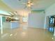 Spacious living room features tile flooring, neutral walls, ceiling fan, and access to the kitchen at 9614 Long Meadow Dr, Tampa, FL 33615