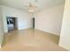 Bright living room features tile floors, fan, and an abundance of natural light at 9614 Long Meadow Dr, Tampa, FL 33615