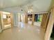 Sunroom with large windows, tiled floors, and neutral color palette at 9614 Long Meadow Dr, Tampa, FL 33615