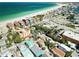 Gorgeous aerial view of beachfront homes and businesses along the serene coastline and bright blue ocean at 100 94Th Ave, Treasure Island, FL 33706