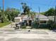 Exterior of a house showing the fenced yard, shed, and various trees on a sunny day at 100 94Th Ave, Treasure Island, FL 33706