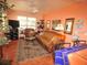 Relaxing living area boasts a leather sofa, stylish decor, and a ceiling fan for comfort at 100 94Th Ave, Treasure Island, FL 33706