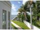 Backyard view overlooking a scenic lake with a boat dock, lush landscaping, and a white fence at 11313 Knights Griffin Rd, Thonotosassa, FL 33592