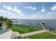 Beautiful backyard with putting green and tranquil lake views at 11313 Knights Griffin Rd, Thonotosassa, FL 33592