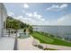 Overhead backyard view featuring a pool, putting green, and tranquil lake at 11313 Knights Griffin Rd, Thonotosassa, FL 33592