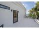 Exterior view from balcony overlooking an outdoor seating area and a scenic lake at 11313 Knights Griffin Rd, Thonotosassa, FL 33592