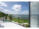 Balcony view showcasing a putting green, pool and peaceful lake at 11313 Knights Griffin Rd, Thonotosassa, FL 33592