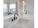 Close up on the double vanity with white marble countertops and modern fixtures at 11313 Knights Griffin Rd, Thonotosassa, FL 33592