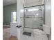 Bright bathroom featuring a glass-enclosed shower and contrasting dark hardware at 11313 Knights Griffin Rd, Thonotosassa, FL 33592