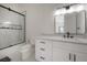 Modern bathroom featuring a sleek vanity, framed mirror, and a glass-enclosed shower for a luxurious feel at 11313 Knights Griffin Rd, Thonotosassa, FL 33592