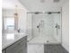 Modern bathroom features a glass-enclosed shower, a luxurious tub, and elegant finishes at 11313 Knights Griffin Rd, Thonotosassa, FL 33592