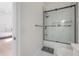 Contemporary bathroom with a glass shower door and a gray rug on a marble tile floor at 11313 Knights Griffin Rd, Thonotosassa, FL 33592