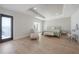 Spacious bedroom featuring tray ceiling, hardwood floors, and access to a private balcony with scenic views at 11313 Knights Griffin Rd, Thonotosassa, FL 33592