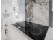 Modern cooktop features marble backsplash and white cabinetry with black hardware at 11313 Knights Griffin Rd, Thonotosassa, FL 33592