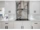 Close up of a modern kitchen's cooktop and hood, framed by white cabinets and marble backsplash at 11313 Knights Griffin Rd, Thonotosassa, FL 33592