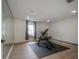 Exercise room includes weight bench, workout machine, mirror and views to outdoors at 11313 Knights Griffin Rd, Thonotosassa, FL 33592